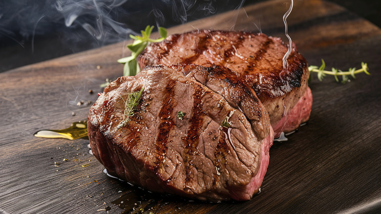 Grilled beef steak on the dark wooden background